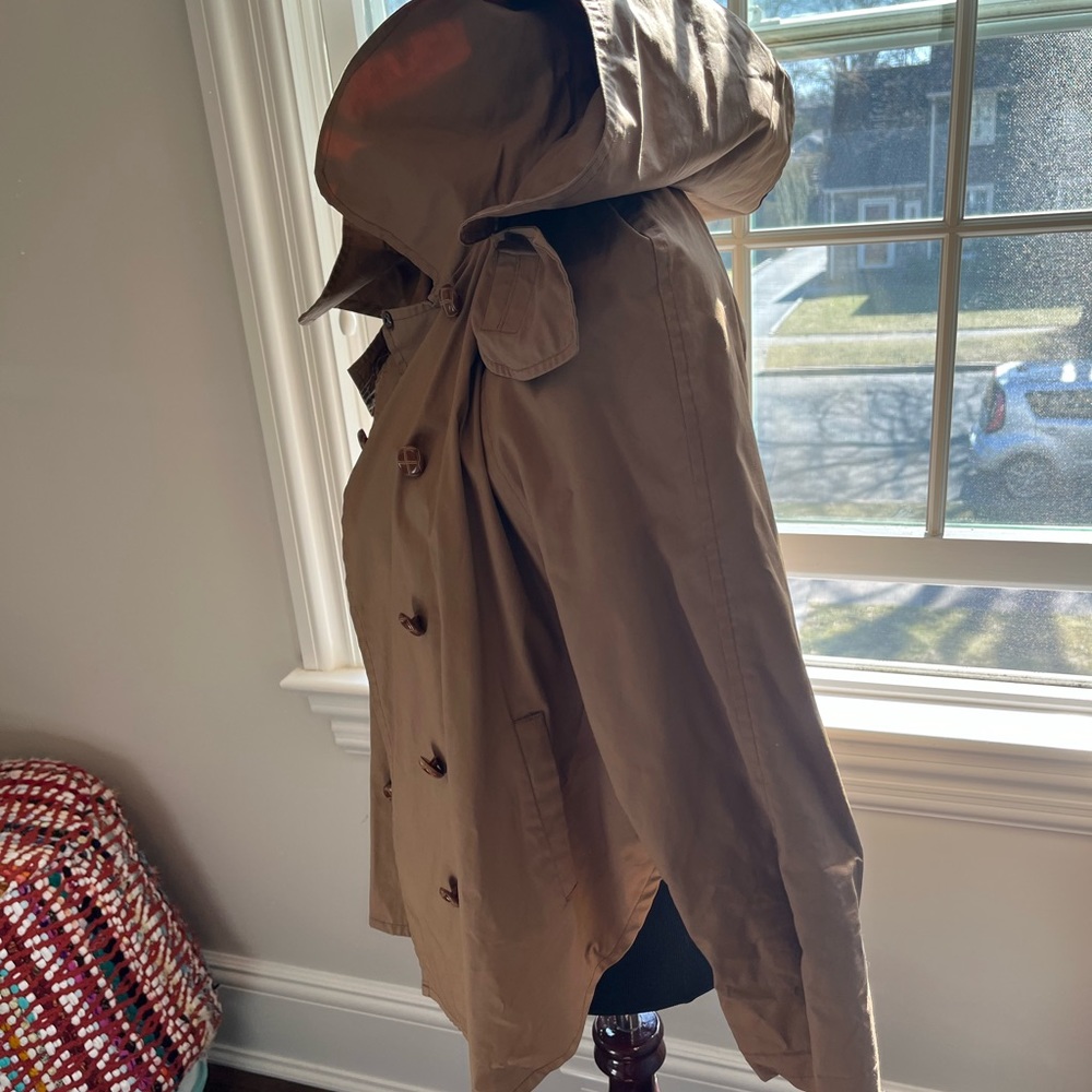Raincoat lined with removable hood